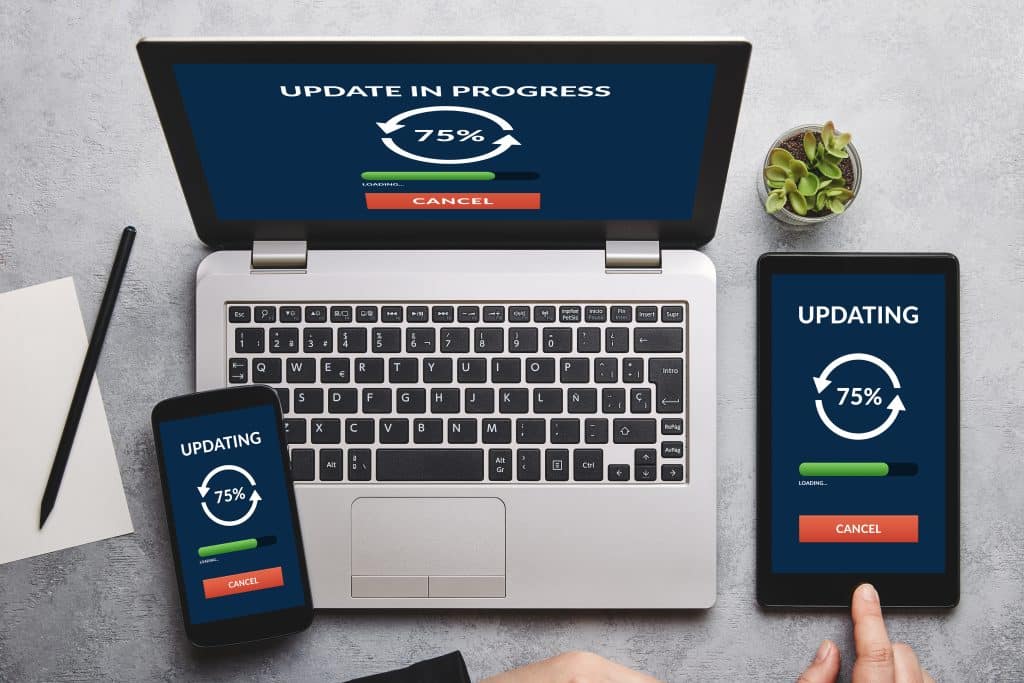 Update concept on laptop, tablet and smartphone screen over gray table. All screen content is designed by me.