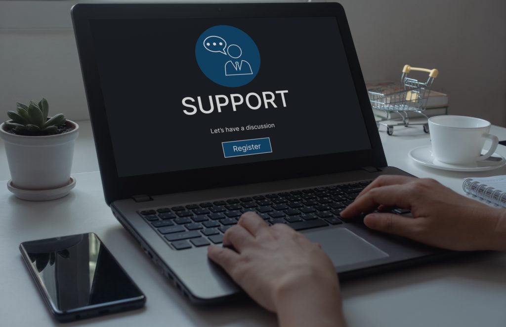 Helpdesk Support Information and Technical Support Concept on laptop computer screen. Hands typing on a keyboard. Technical Support Center Customer Service Internet Business Technology.