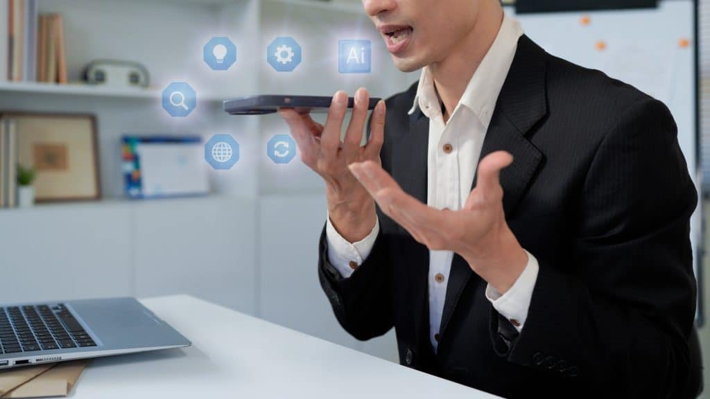 Man using AI voice assistant on smartphone with speech-to-text conversion and chatbot interface, representing smart technology, digital assistant and virtual communication.